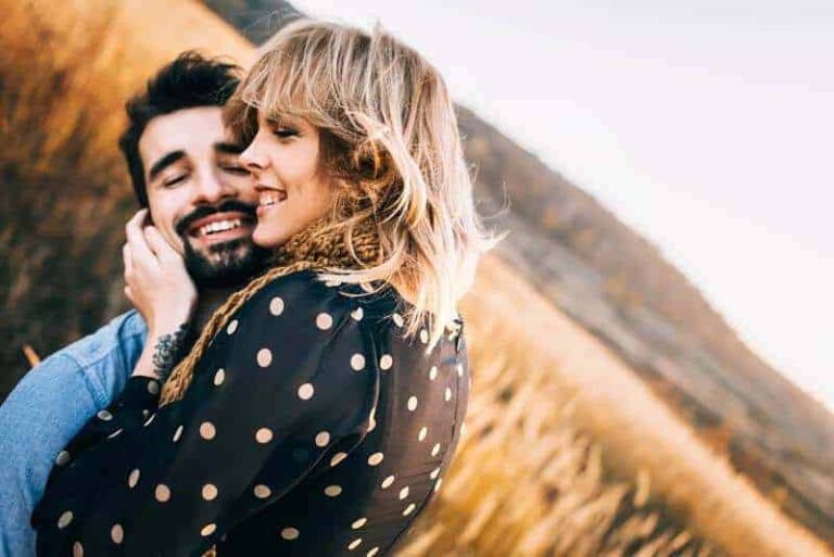 lovely couple hugging outside in field