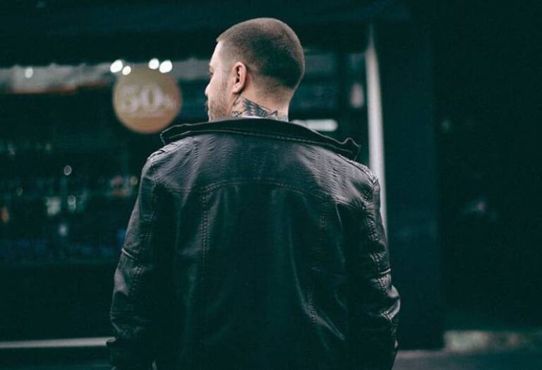 back view of man wearing black jacket walking outside