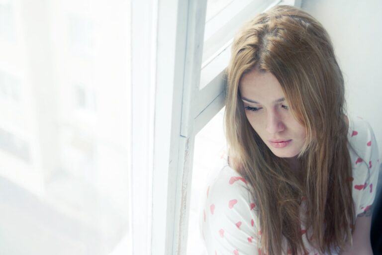 a woman sitting by the window