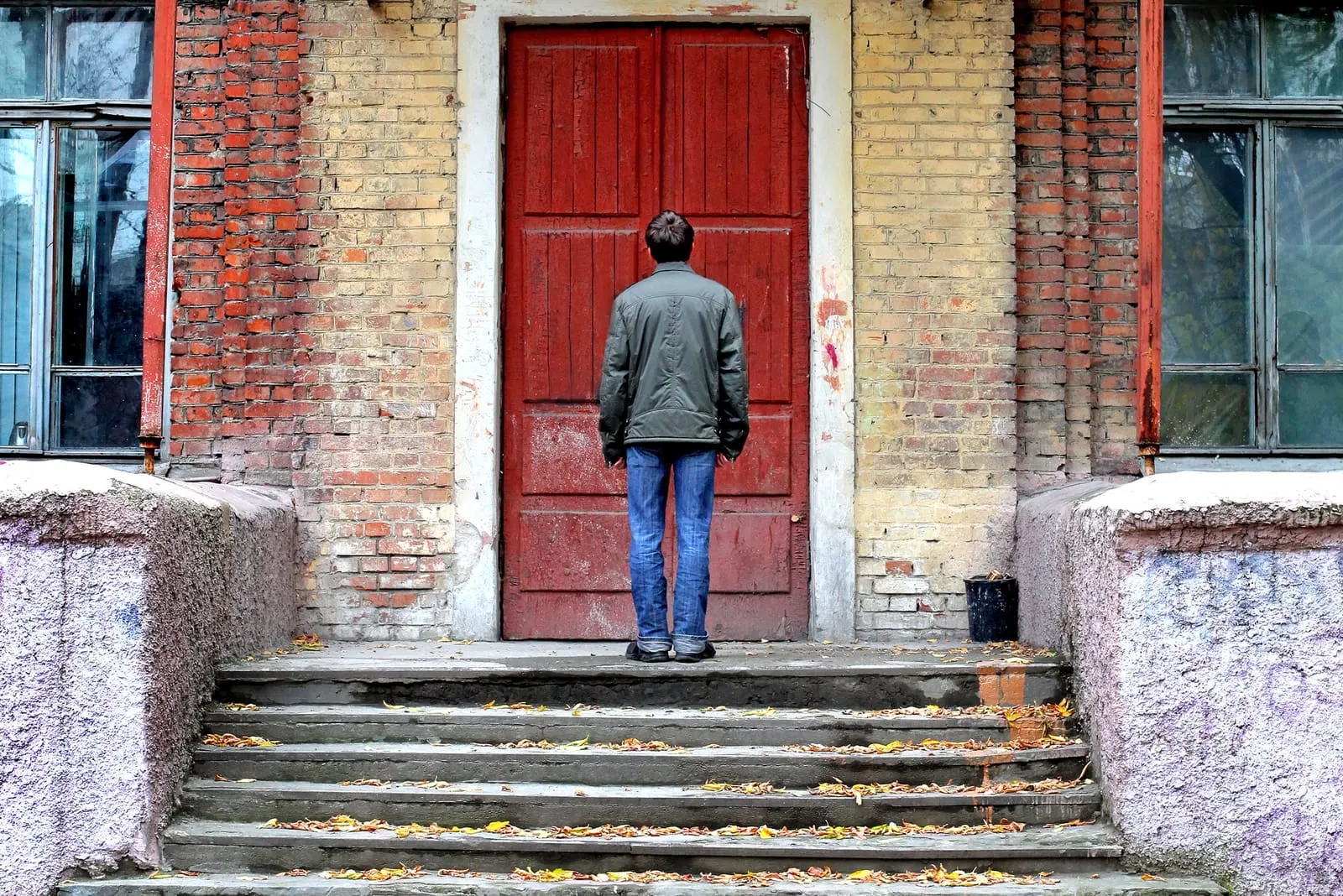a man stands in front of the door
