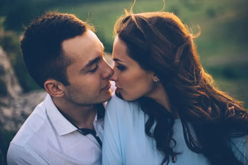 attractive woman kissing a man