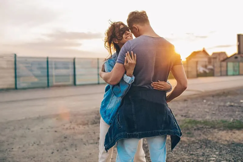 couple hugging at sunset