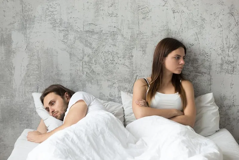 couple laying in bed in silence