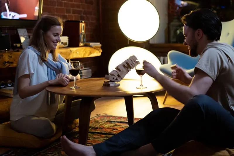 couple playing game and drinking wine