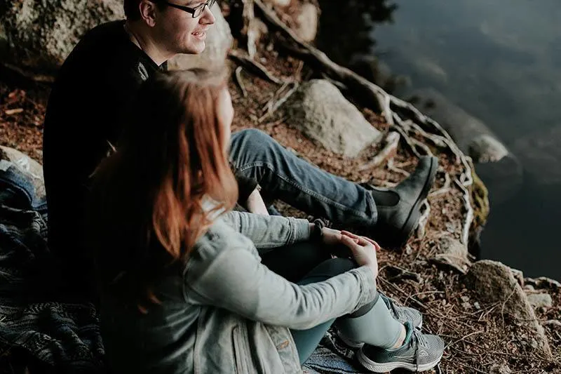 couple talking in front of lake