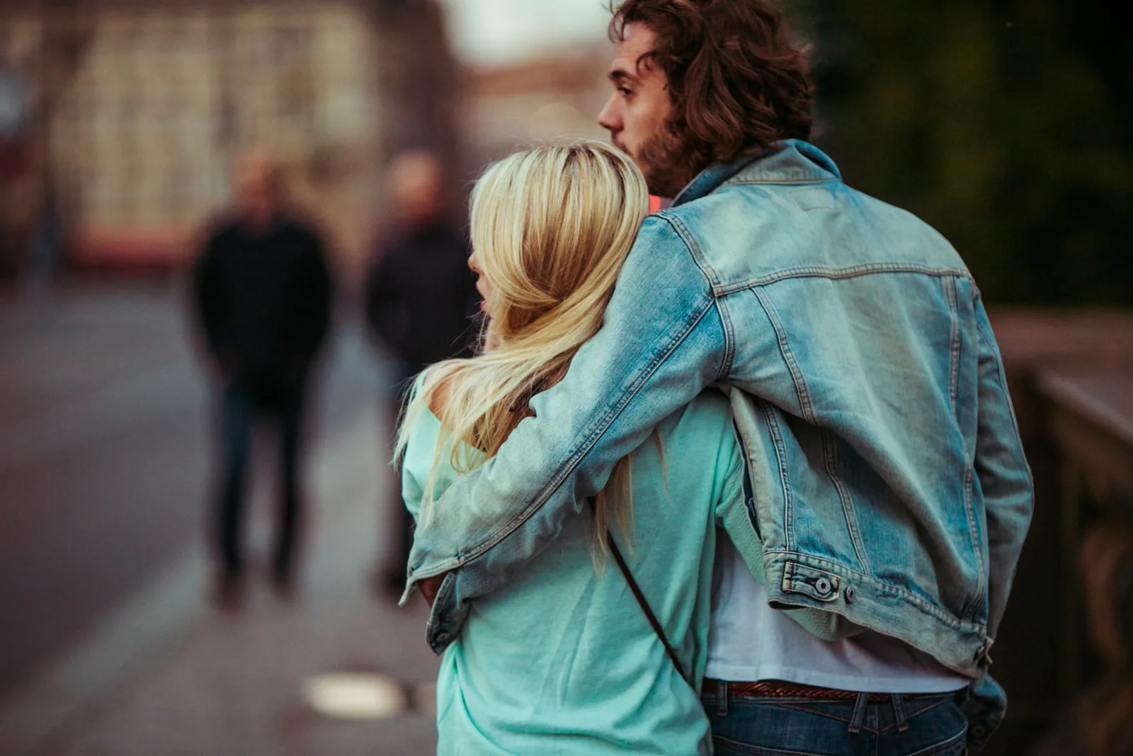 couple walking on the street hugging