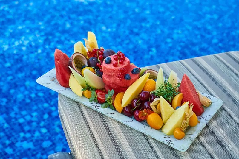 fruits on plate by the pool