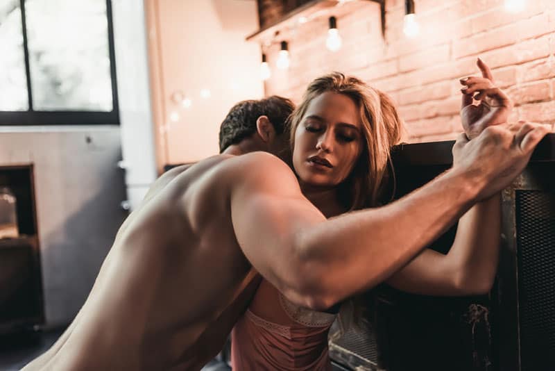 handsome man kissing womans neck