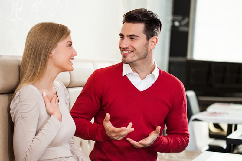 handsome man talking to surprised woman