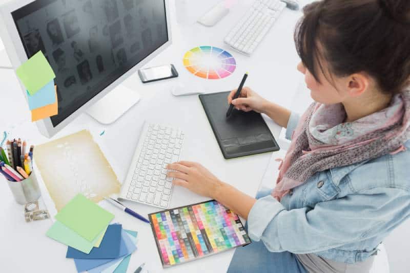 high angle view of woman drawin something on graphic tablet