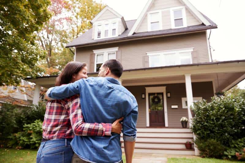 loving couple walking towards house