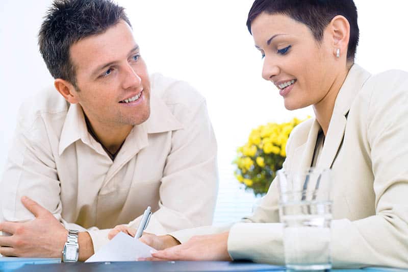 man curiously looking at woman in office