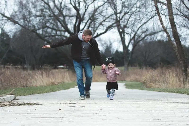 man running with little girl