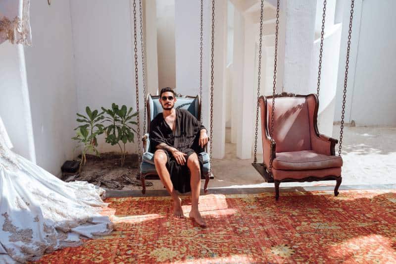 man wearing sunglasses and sitting on sofa