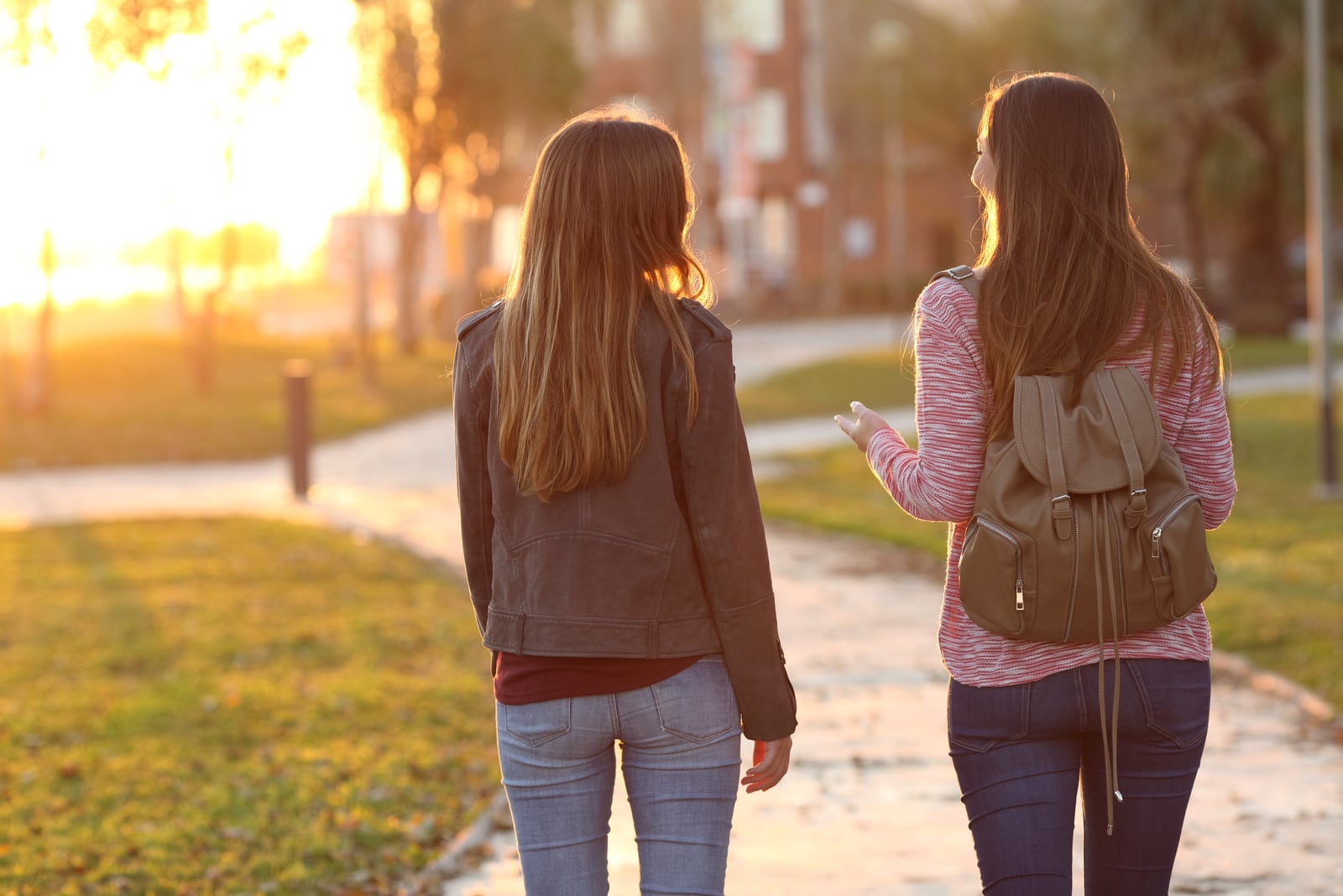 two friends walking together in a park