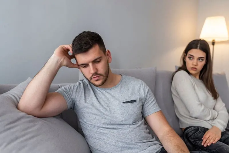 unhappy couple sitting side by side