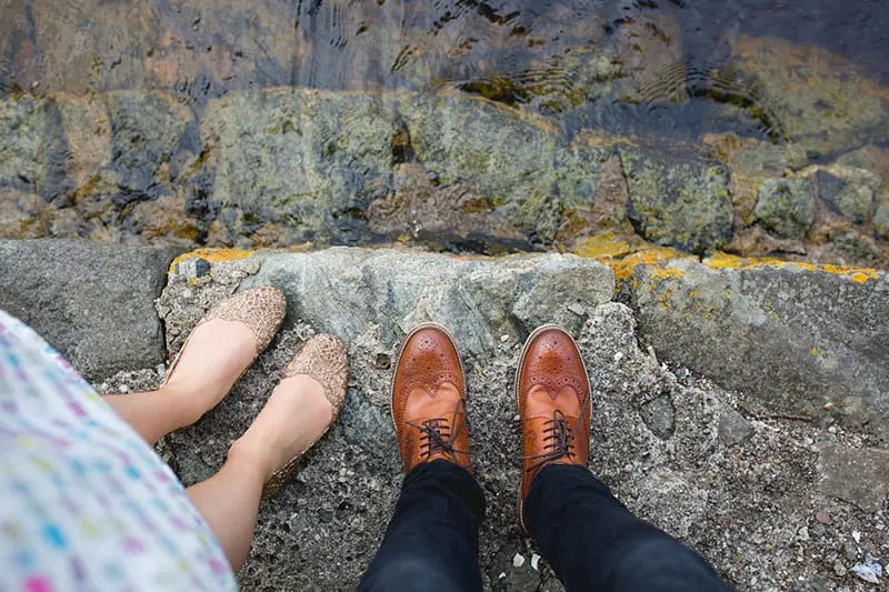 woman and man standing in leather and lace shoes