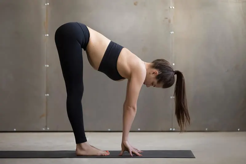 woman in yoga pants stretching