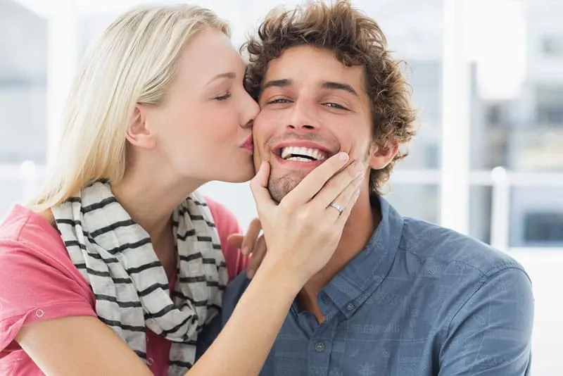 woman kissing a man in the cheek