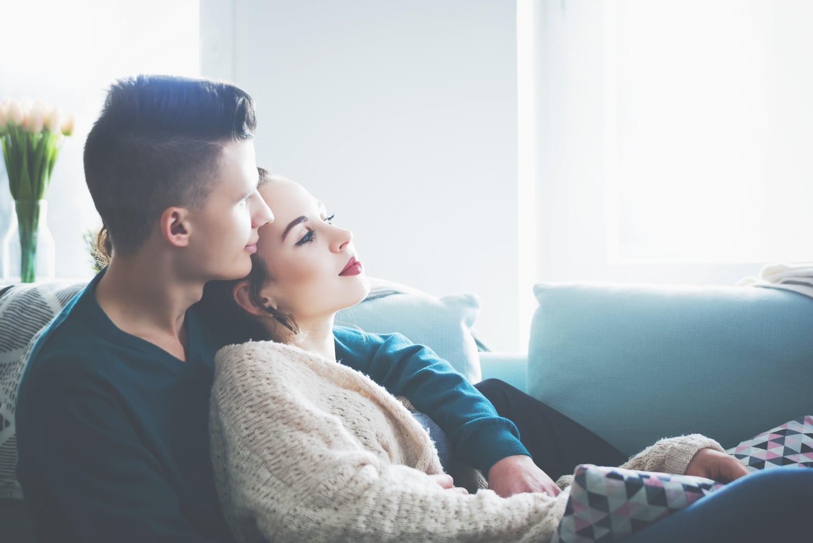 young couple hugging and relaxing on sofa