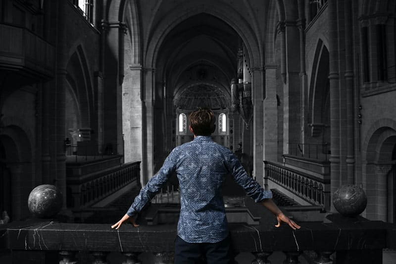 young man standing in big building