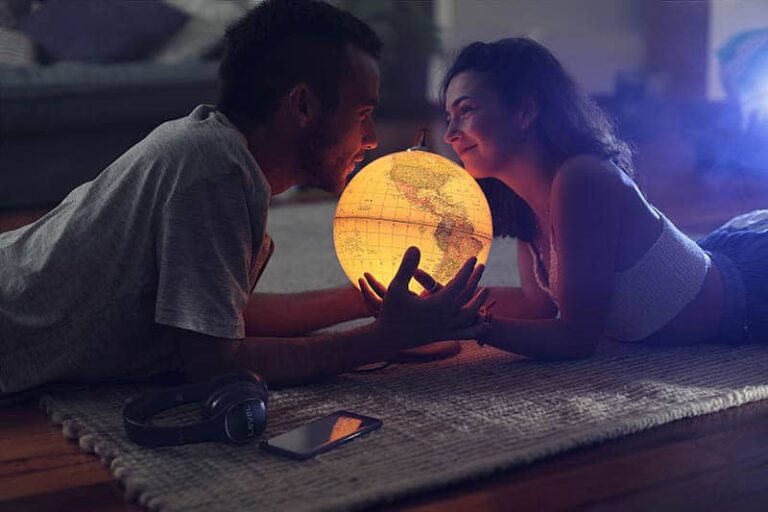 romantic couple holding earth globe