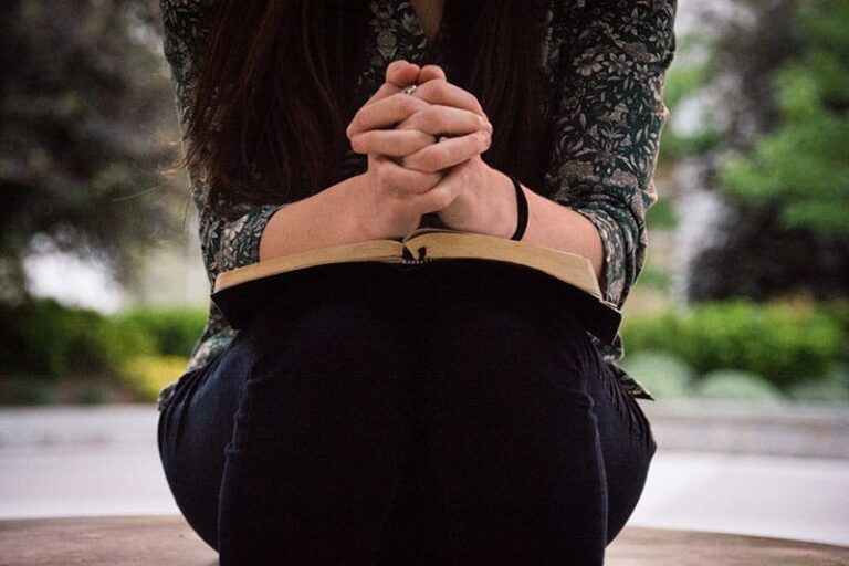woman holding bible on her legs
