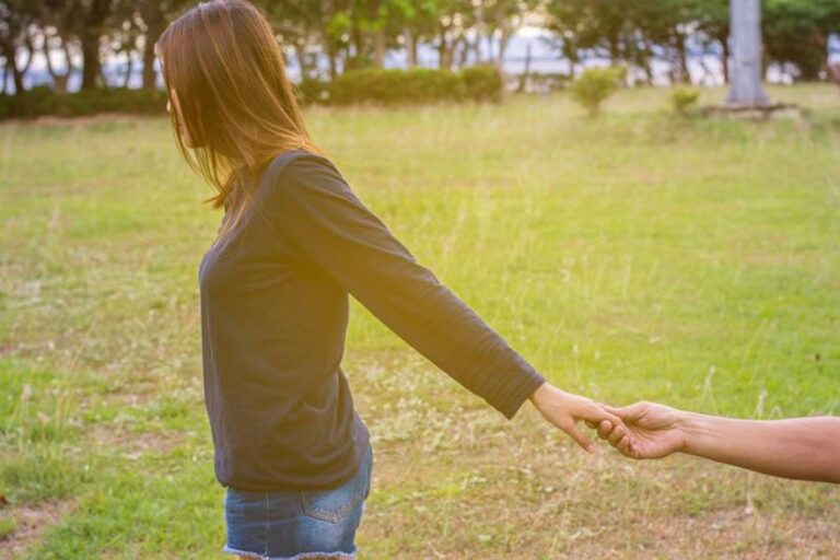 the man holds the woman's hand