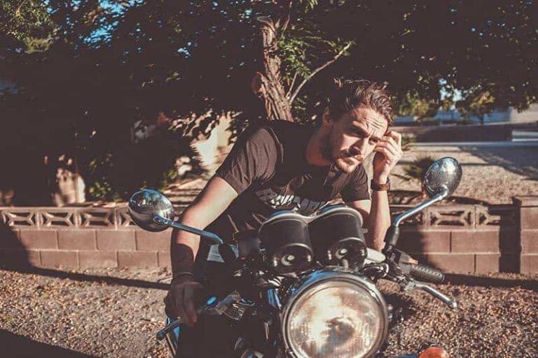 man sitting on motorcycle