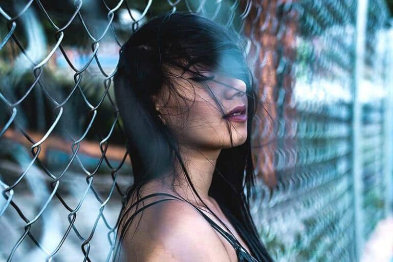 sad woman leaning on the fence