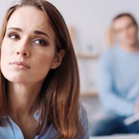 sad worried woman sitting in front of man