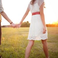 couple holding hands and walking