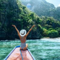 woman spreading arms on the boat