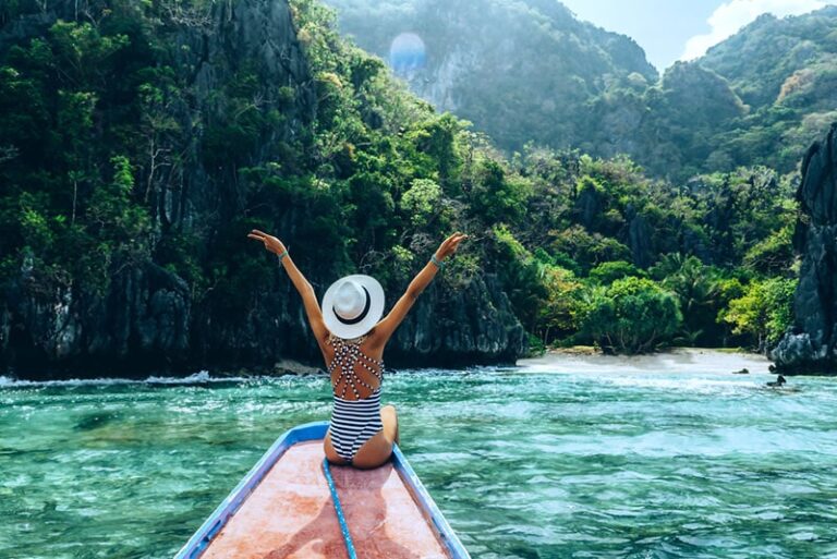 woman spreading arms on the boat