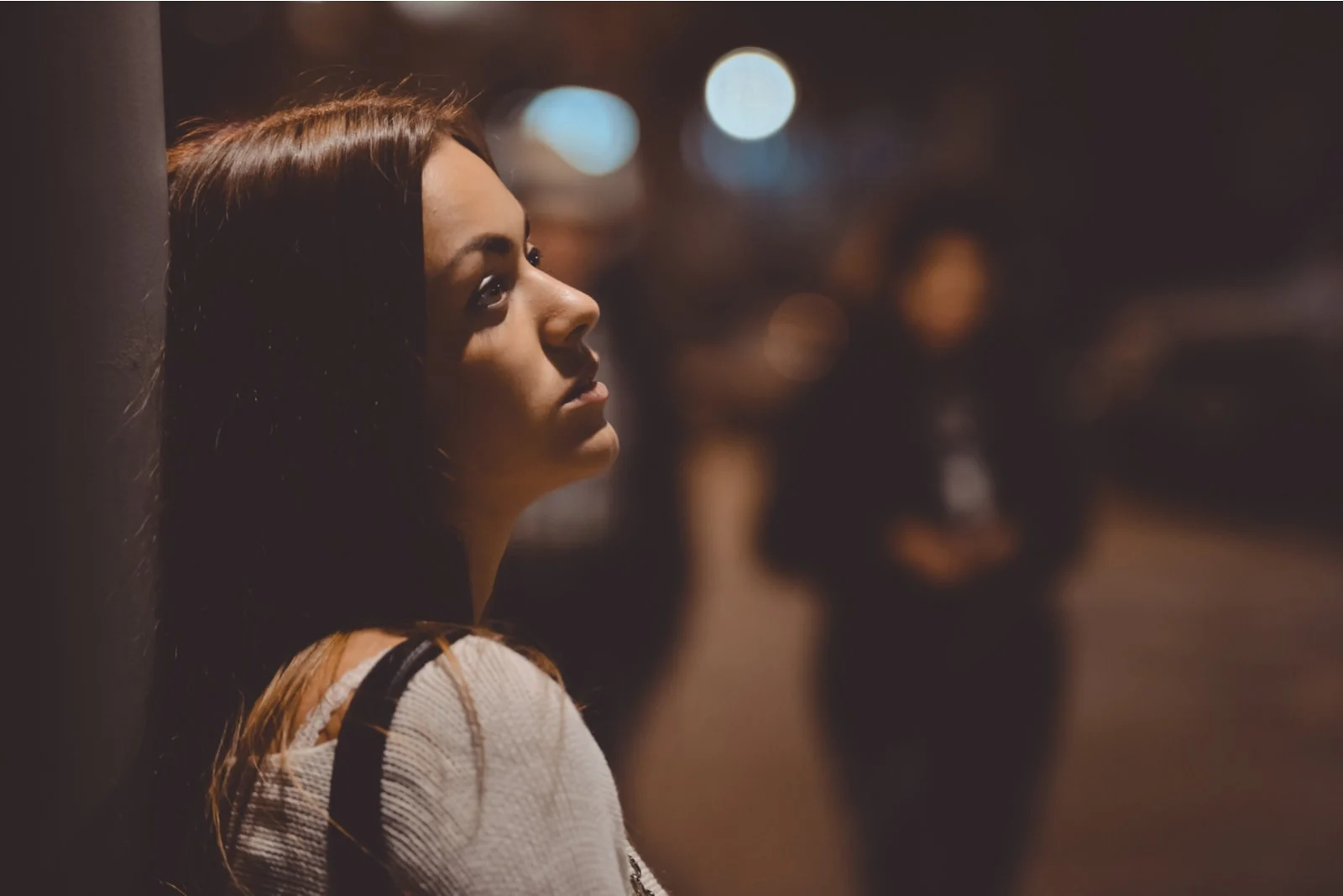 a disappointed woman leaned against the wall