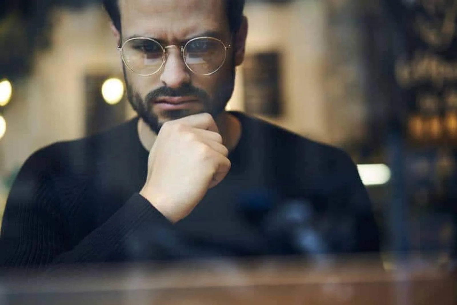 bearded man with glasses looking worried