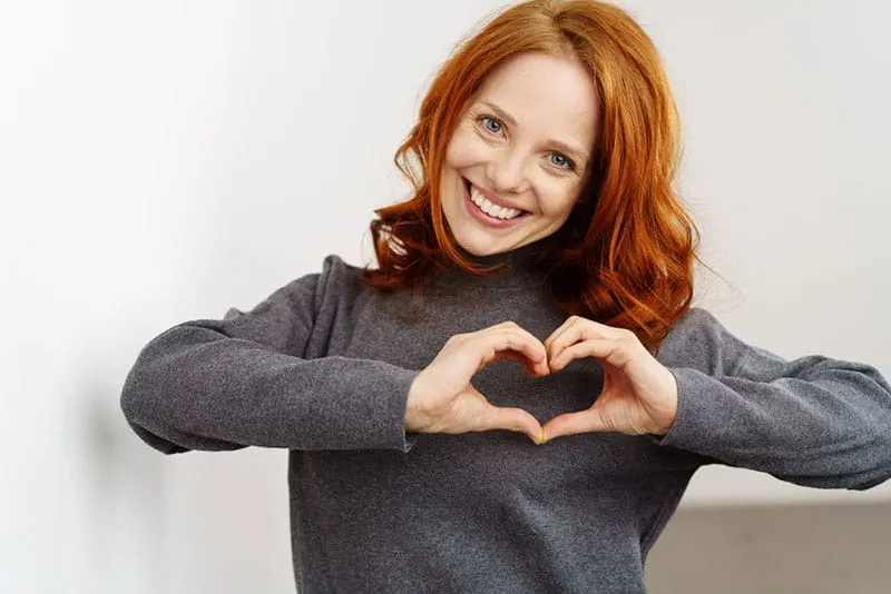 beautiful woman making heart with hands