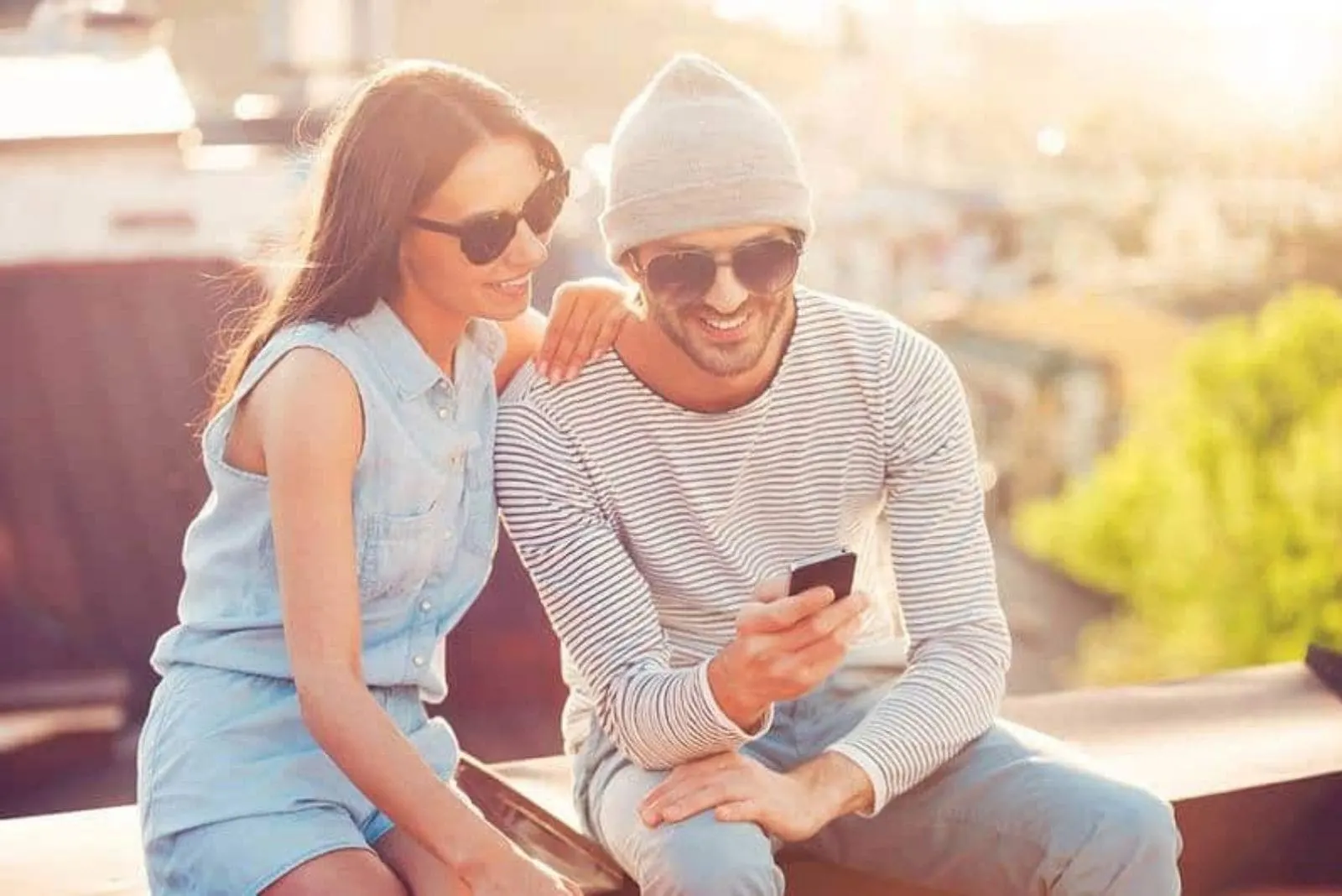 couple looking at smartphone and smiling