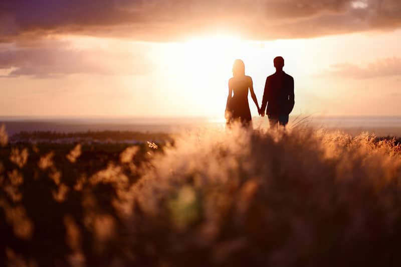 couple standing in the meadow