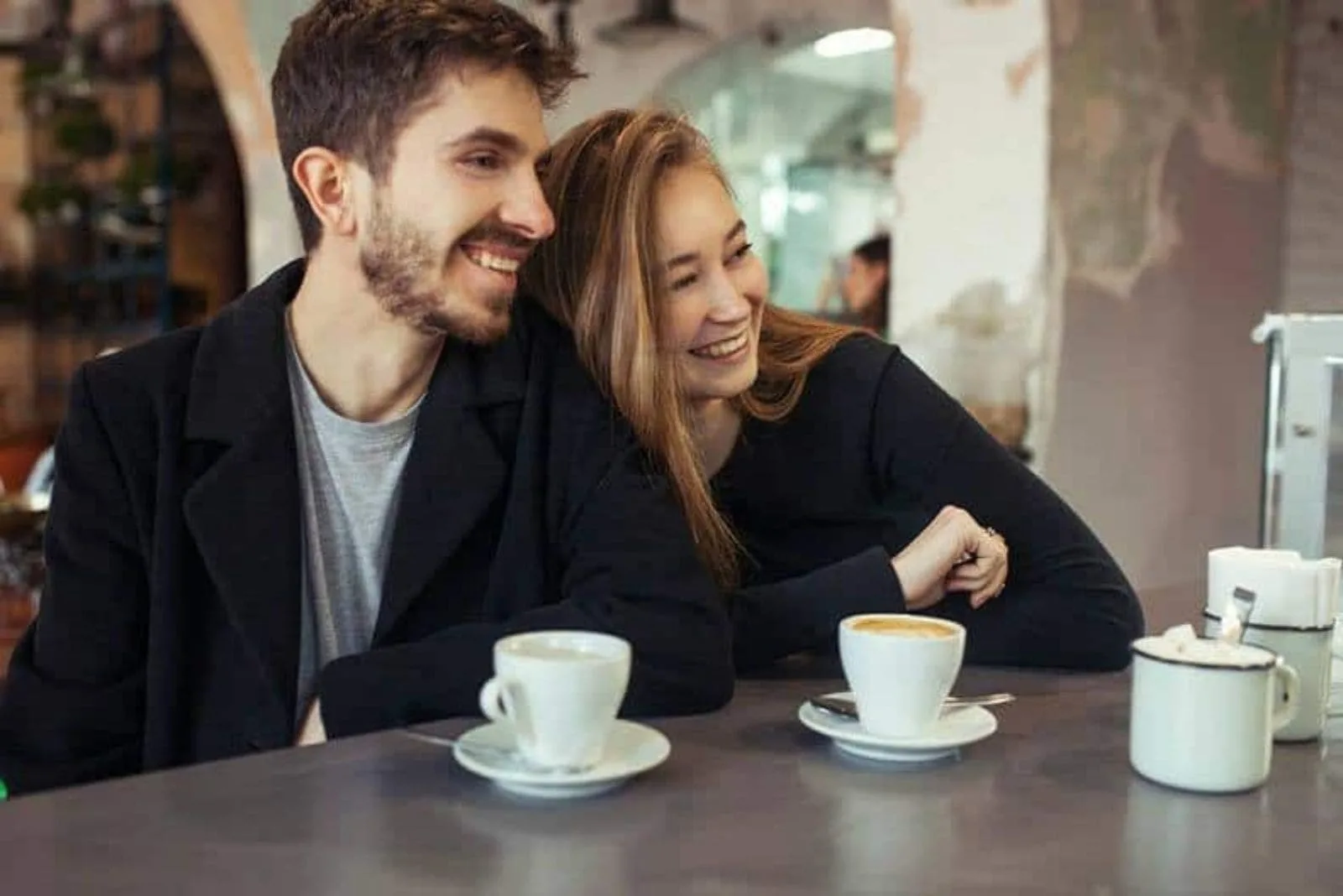 happy couple drinking coffee and laughing