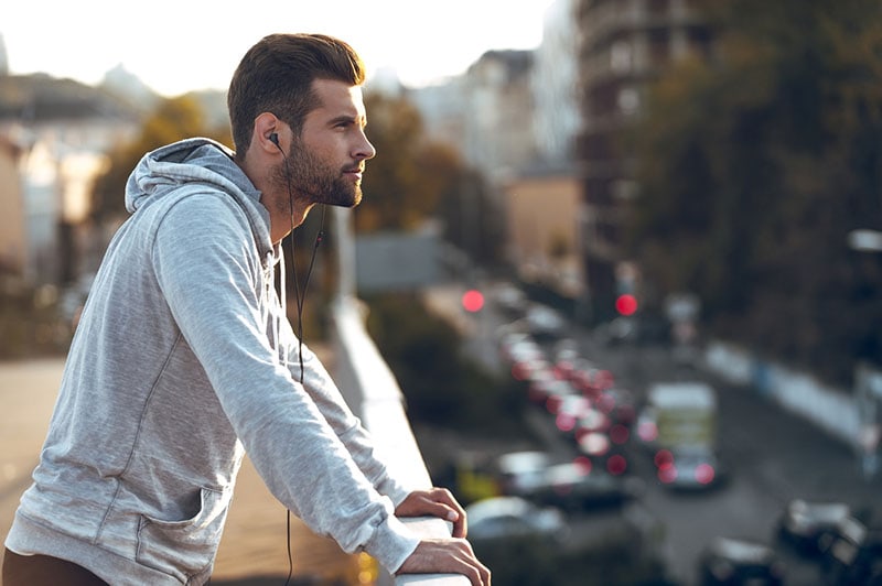 man listens music on earphones