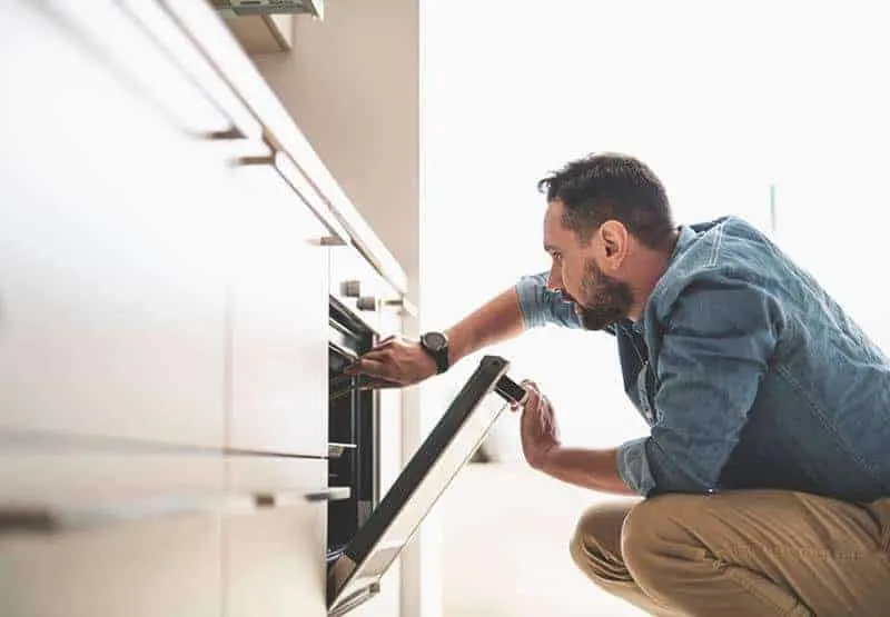 man opening oven