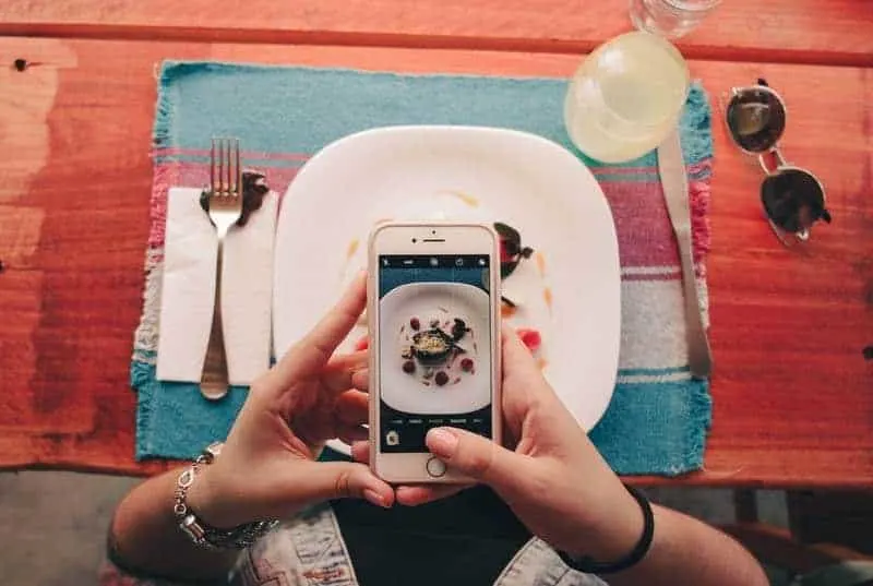 man taking picture of food
