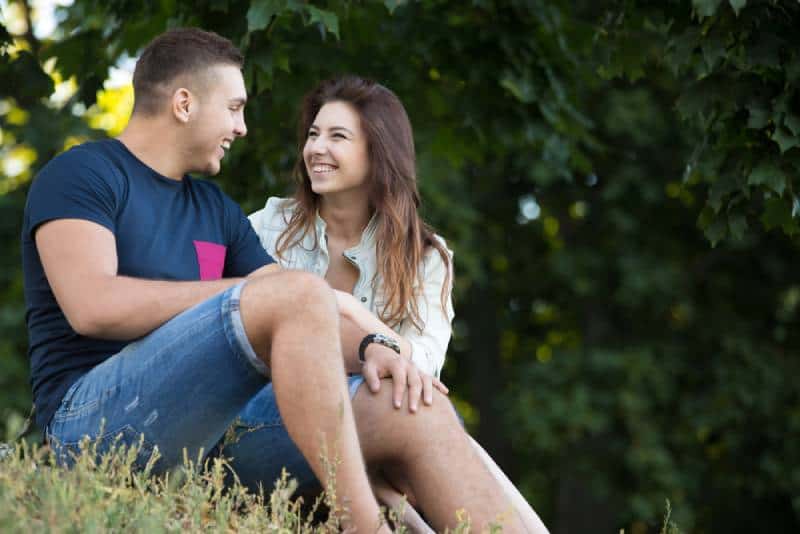 portrait of couple sitting outside and talking