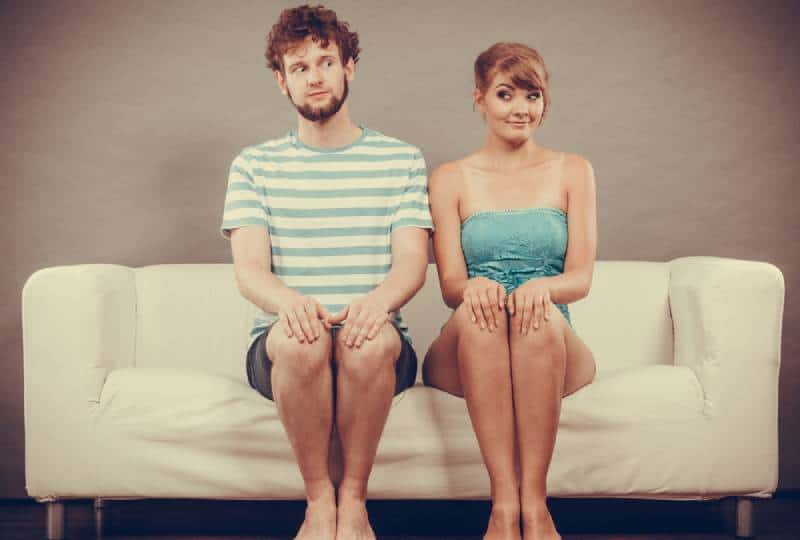 shy couple sitting at couch