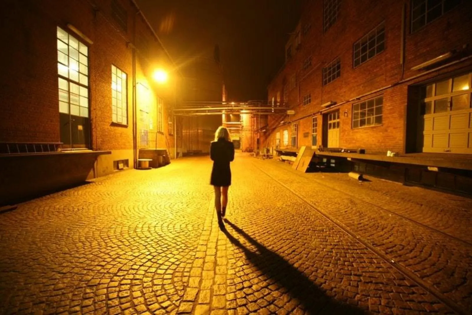 the woman walks down the street alone