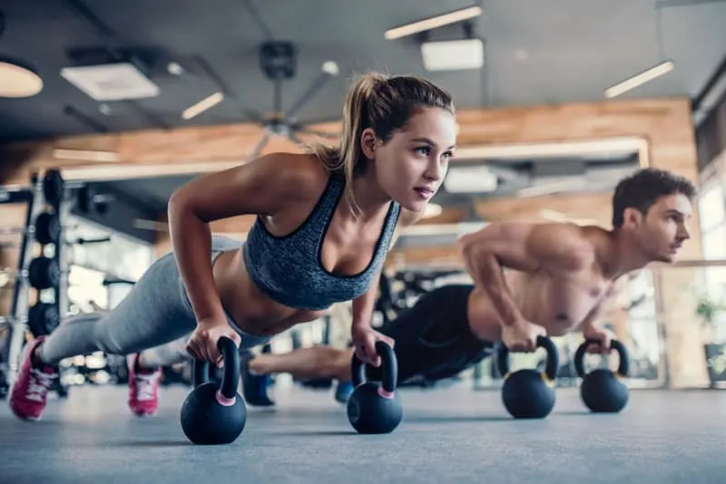 woman and man working out in the gym