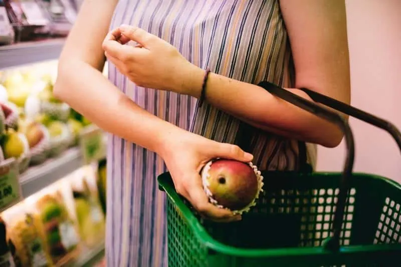 woman buying an apple in the supermarket