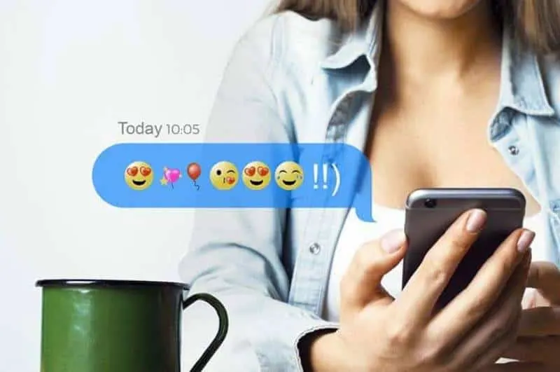 woman holding phone with emoji