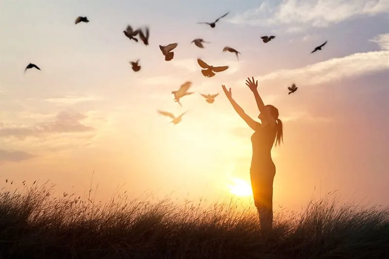 woman spreading arms to the birds